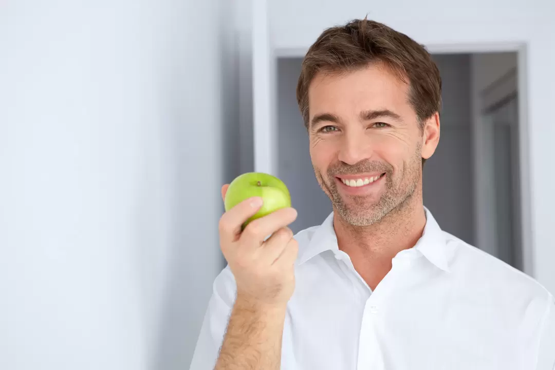 a man eats an apple for power